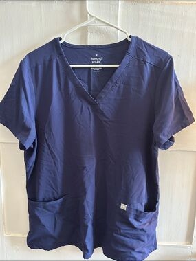 Beyond Scrubs Navy blue scrub top with pockets.
Size Large